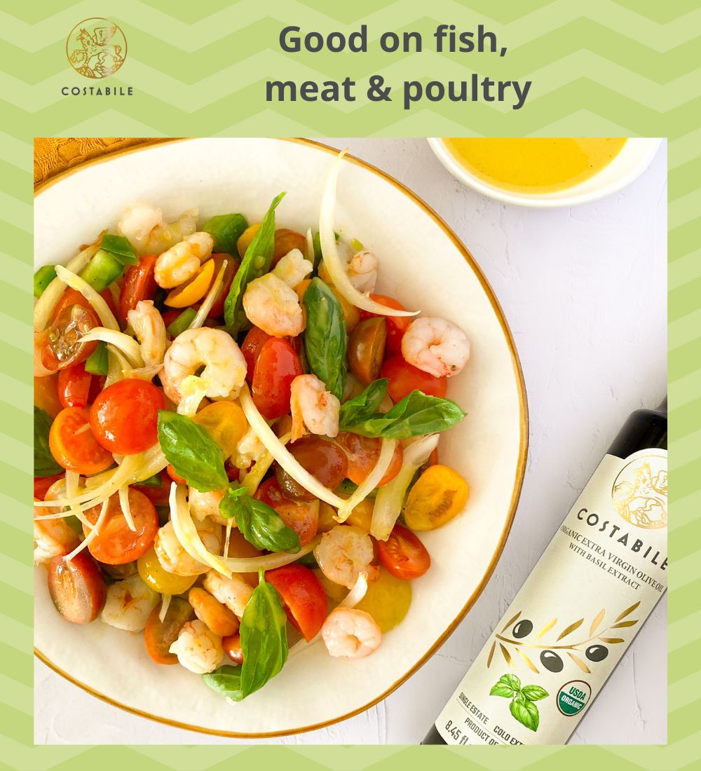 Basil infused olive oil extra virgin from Puglia Italy used as dressing oil on a shrimp salad