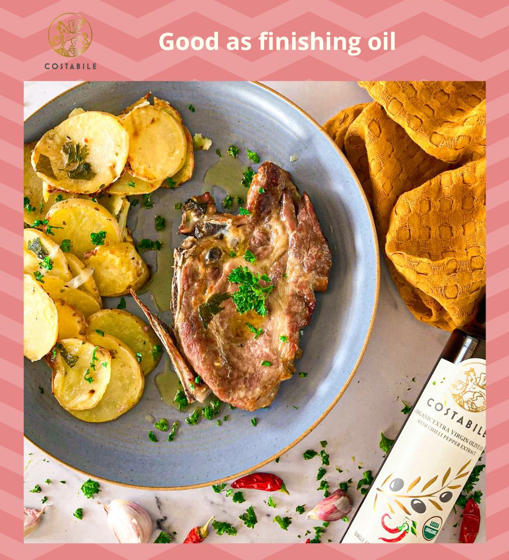 Hot chili oil - Chili pepper infused olive oil extra virgin from Puglia Italy as finished oil on grilled pork meat and baked potatoes - Costabile - Bottle 8.45 Fl. Oz