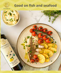 Lemon olive oil used as finishing oil on steamed fish with cherry tomatoes and baked potatoes - Costabile Olive Oil from Puglia Italy