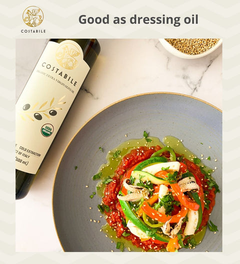 Organic extra virgin Olive Oil from Puglia Italy used as salad dressing oil on a veggies salad